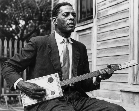 Blind Willie Johnson playing a cigar box guitar
